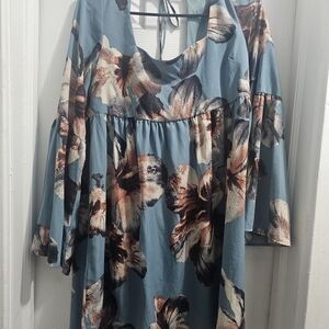 ￼

This is an Altar'd State Blue Floral Square Neck Tie Back Mini Dress